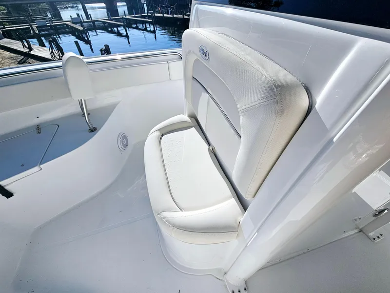 Slide: The Image of 2025 Sea Hunt Ultra 235 SE boat interior with white cushioned seating. - 18