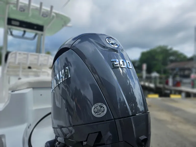 Slide: The Image of 2025 Sea Hunt Ultra 235 SE with Yamaha 200 engine at dockside. - 2