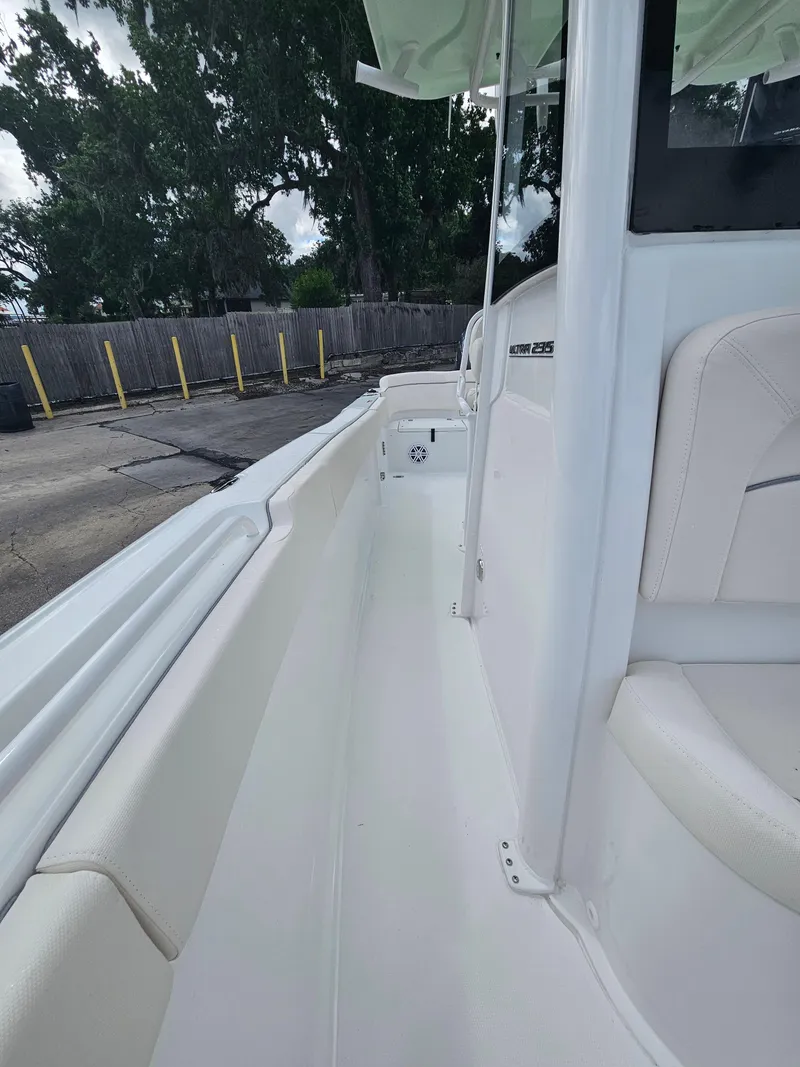 Slide: The Image of 2025 Sea Hunt Ultra 235 SE boat interior with white seating and sleek design. - 21