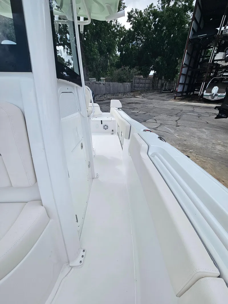 Slide: The Image of 2025 Sea Hunt Ultra 235 SE boat interior with white seating and spacious deck. - 22