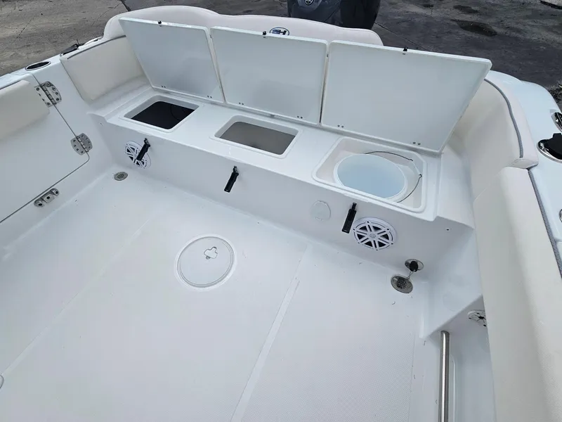 Slide: The Image of 2025 Sea Hunt Ultra 235 SE boat interior with storage compartments and speakers. - 26
