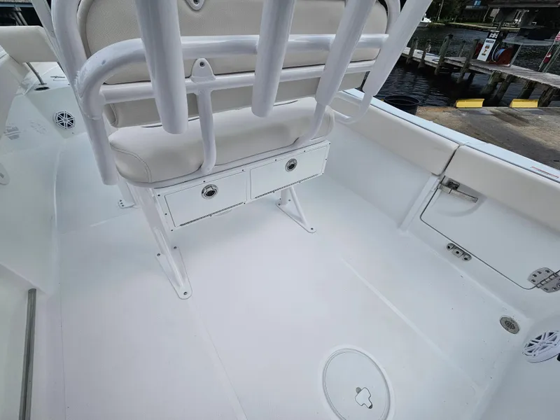 Slide: The Image of Interior of 2025 Sea Hunt Ultra 235 SE boat, featuring seating and storage compartments. - 27