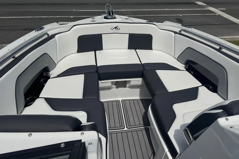 Slide: The Image of 2023 Monterey M-65 boat interior with sleek white and black seating design. - 2