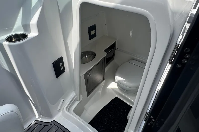 Slide: The Image of 2023 Monterey M-65 boat interior bathroom with sink and toilet. - 4