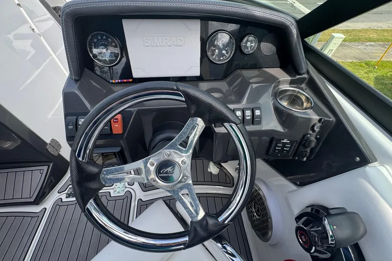Slide: The Image of 2023 Monterey M-65 boat dashboard with steering wheel and control panel. - 7