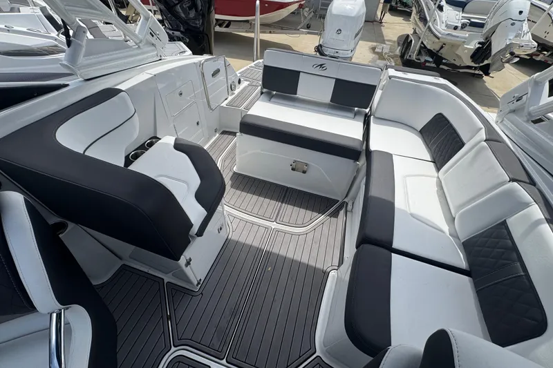 Slide: The Image of 2023 Monterey M-65 boat interior with sleek black and white seating and modern design. - 8