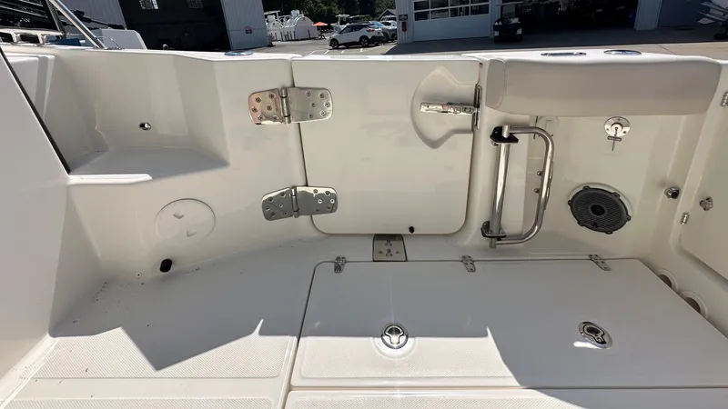 Slide: The Image of 2026 Boston Whaler 325 Conquest boat deck with storage compartments and stainless steel fixtures. - 11