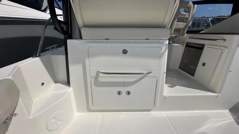 Slide: The Image of 2026 Boston Whaler 325 Conquest interior with storage compartments and seating. - 20