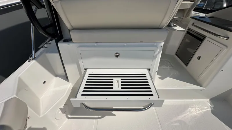 Slide: The Image of 2026 Boston Whaler 325 Conquest interior with seating and storage features. - 21