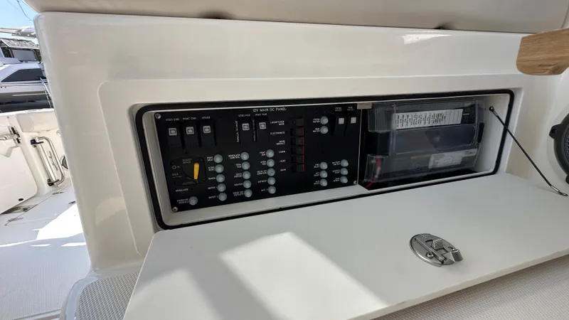 Slide: The Image of Control panel on 2026 Boston Whaler 325 Conquest boat, featuring switches and circuit breakers. - 33
