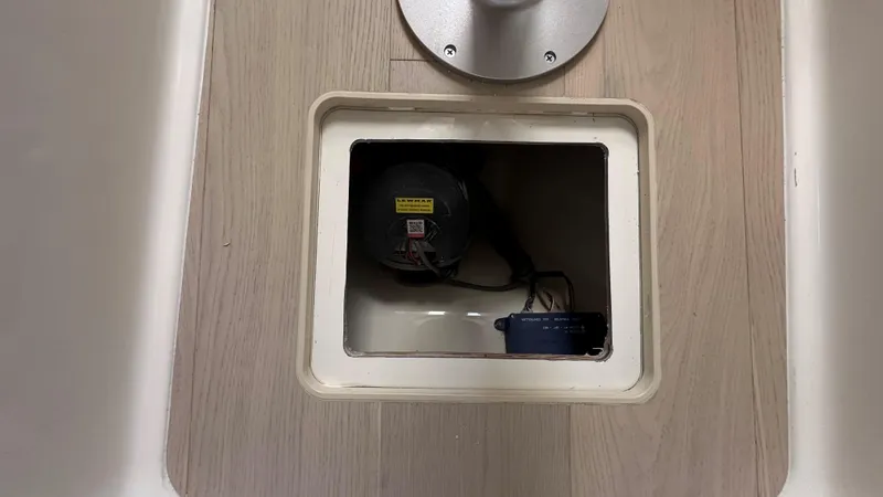 Slide: The Image of Access hatch on 2026 Boston Whaler 325 Conquest boat floor, revealing internal components. - 42