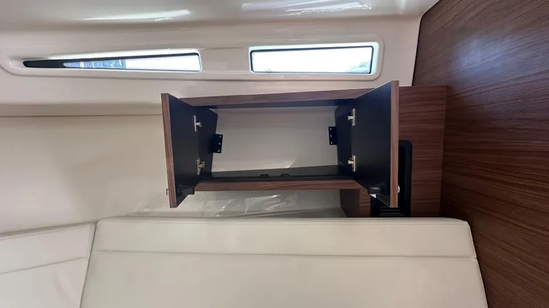 Slide: The Image of Open cabinet inside 2026 Boston Whaler 325 Conquest boat interior. - 43