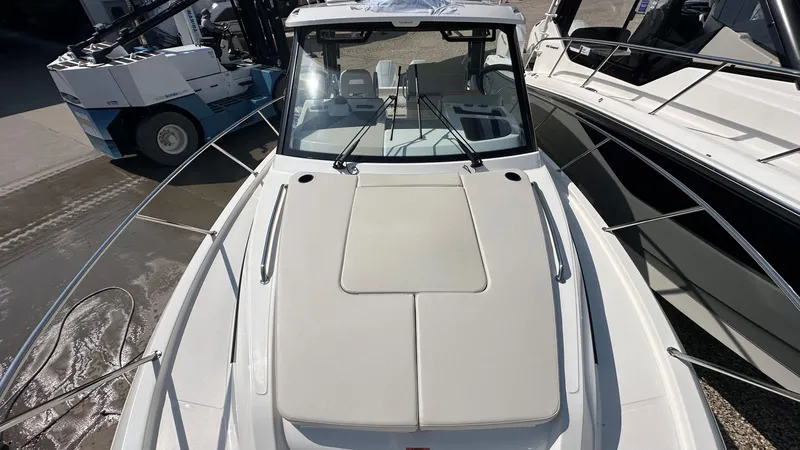 Slide: The Image of 2026 Boston Whaler 325 Conquest boat, top view, docked beside another vessel. - 53