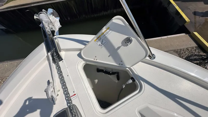 Slide: The Image of Open anchor locker on 2026 Boston Whaler 325 Conquest boat, showing storage compartment. - 55