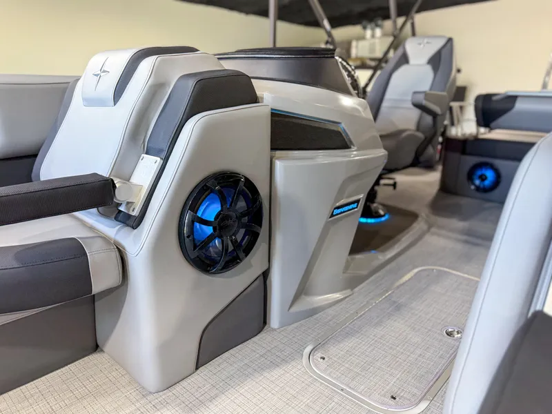 Slide: The Image of 2025 Berkshire 23SBE STS boat interior with modern seating and blue-lit speakers. - 11