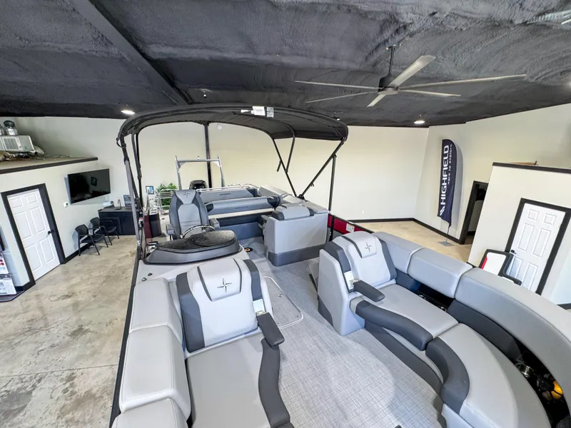 Slide: The Image of 2025 Berkshire 23SBE STS pontoon boat interior with modern seating in showroom. - 16