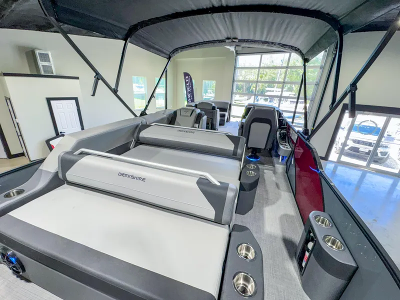 Slide: The Image of 2025 Berkshire 23SBE STS pontoon boat interior with seating and cup holders. - 18