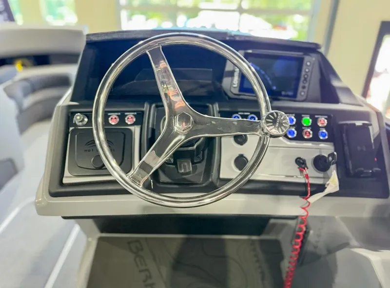 Slide: The Image of Steering console of 2025 Berkshire 23SBE STS boat with control panel and gauges. - 19