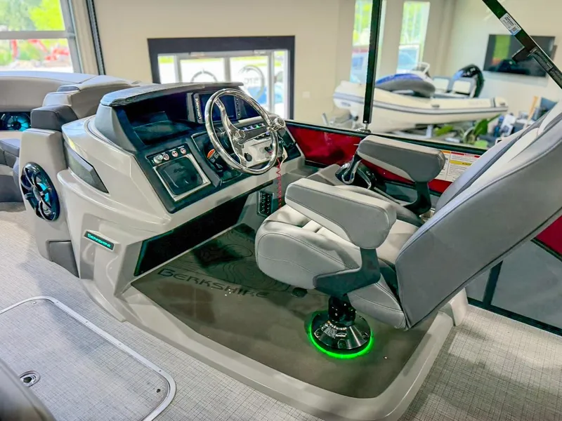Slide: The Image of 2025 Berkshire 23SBE STS boat helm with modern controls and comfortable seating. - 20