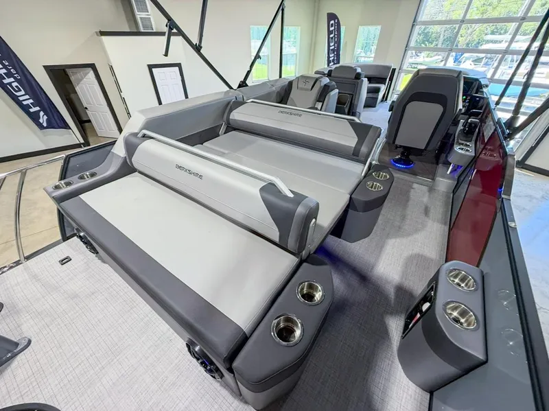 Slide: The Image of 2025 Berkshire 23SBE STS pontoon boat interior with luxurious seating and cup holders. - 23