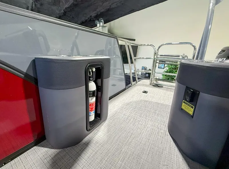 Slide: The Image of 2025 Berkshire 23SBE STS boat interior with fire extinguisher and safety features. - 25