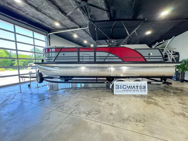 Slide: The Image of 2025 Berkshire 23SBE STS pontoon boat displayed indoors at Big Water Marine. - 3