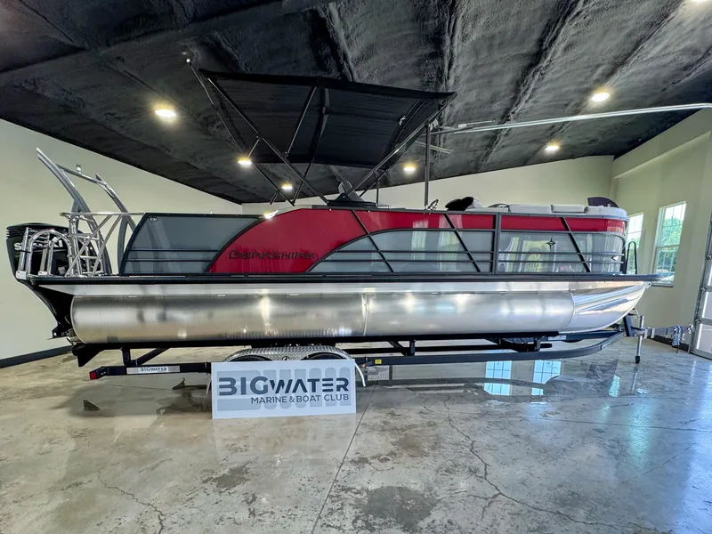 Slide: The Image of 2025 Berkshire 23SBE STS pontoon boat displayed indoors at Big Water Marine. - 8