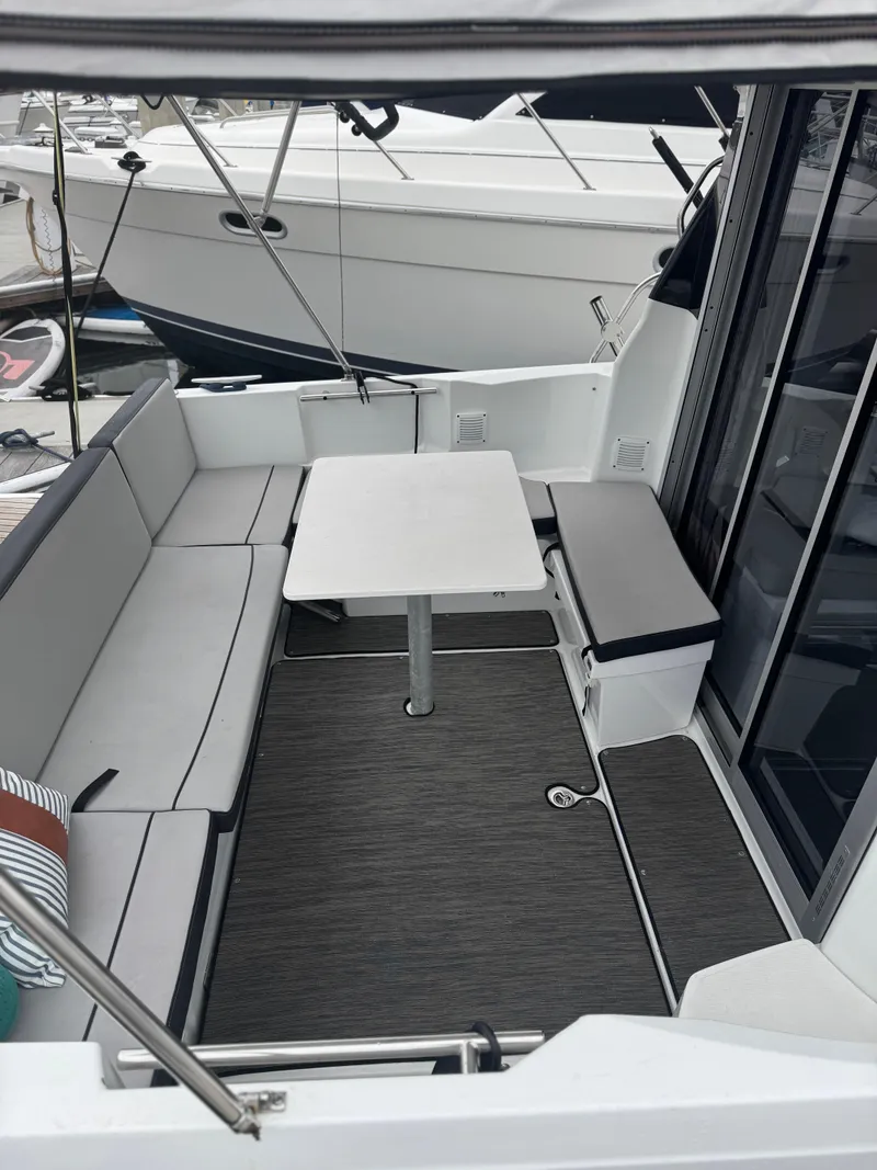 Slide: The Image of Jeanneau NC 795 boat interior, 2020 model, featuring seating and a table. - 20