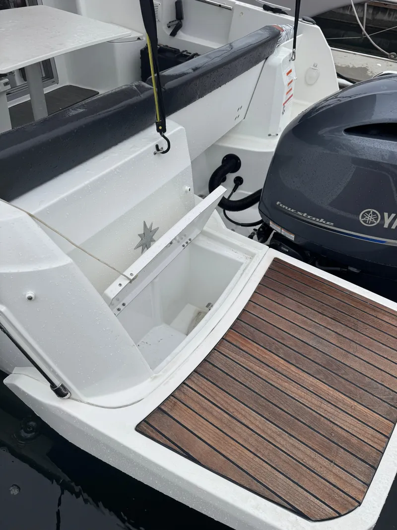 Slide: The Image of 2020 Jeanneau NC 795 boat with Yamaha outboard motor and wooden deck. - 23