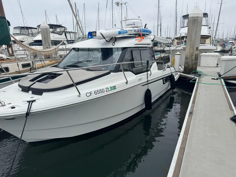 Slide: The Image of 2020 Jeanneau NC 795 boat docked at a marina, featuring sleek design and modern equipment. - 3