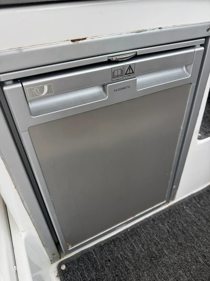 Slide: The Image of Compact Dometic fridge on 2020 Jeanneau NC 795 boat interior. - 32