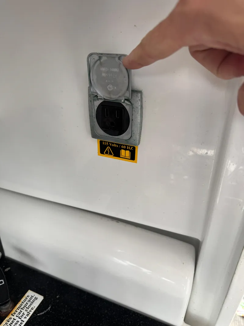 Slide: The Image of Boat power outlet on Jeanneau NC 795, 2020 model, with 115 volts, 60 Hz label. - 33