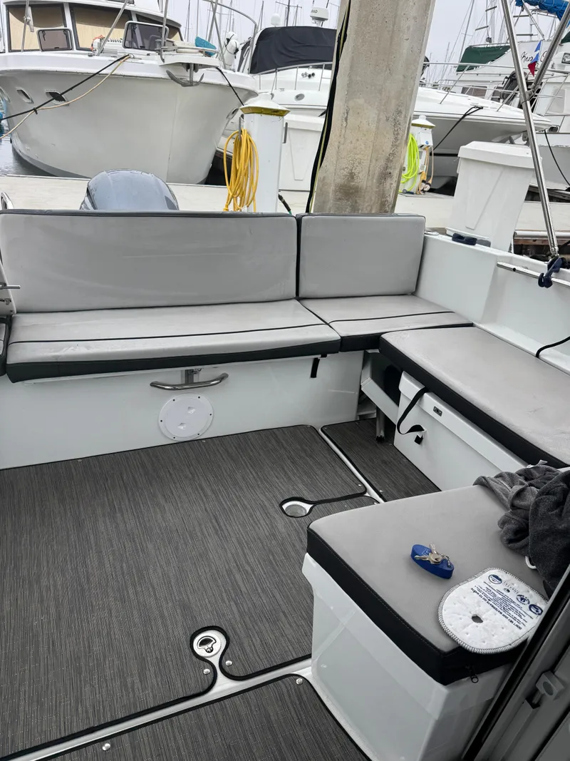 Slide: The Image of Interior of a 2020 Jeanneau NC 795 boat with gray seating and deck. - 34