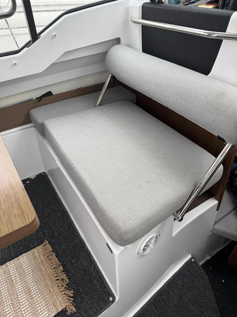 Slide: The Image of Interior seating of a 2020 Jeanneau NC 795 boat with gray cushions. - 35