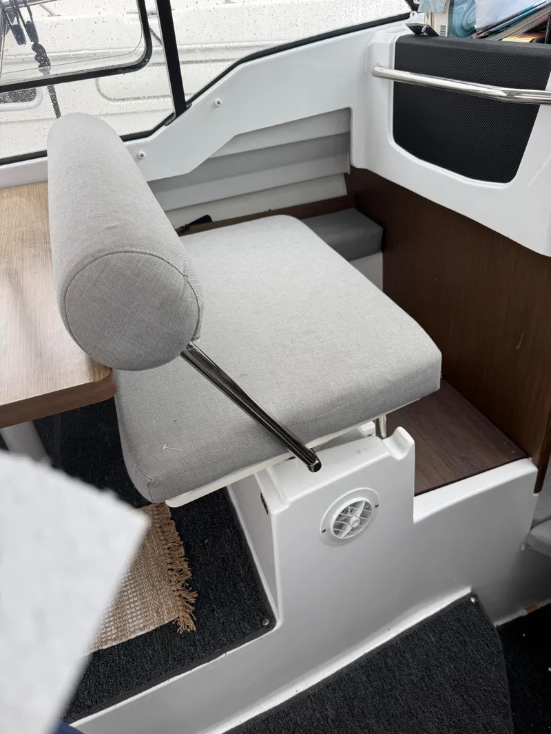 Slide: The Image of Interior seating of a 2020 Jeanneau NC 795 boat, featuring a cushioned bench. - 36
