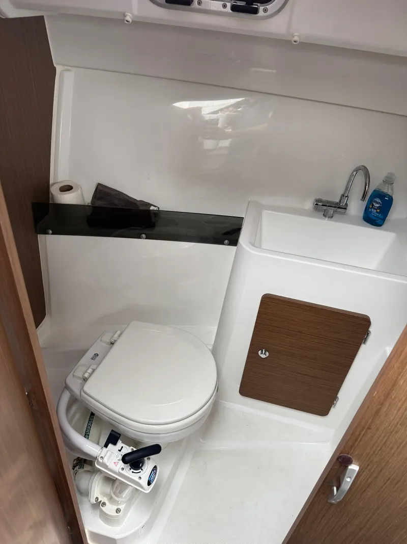 Slide: The Image of Compact bathroom in 2020 Jeanneau NC 795 boat with toilet, sink, and storage. - 38