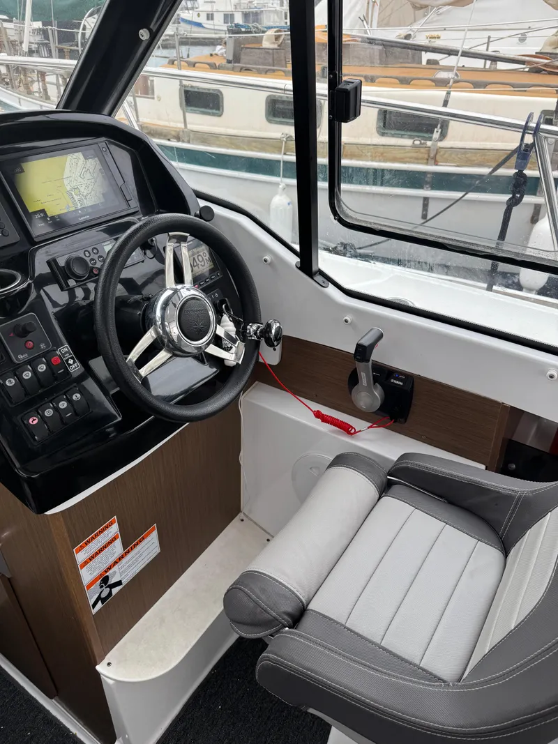 Slide: The Image of Interior of 2020 Jeanneau NC 795 boat showing steering wheel and control panel. - 43