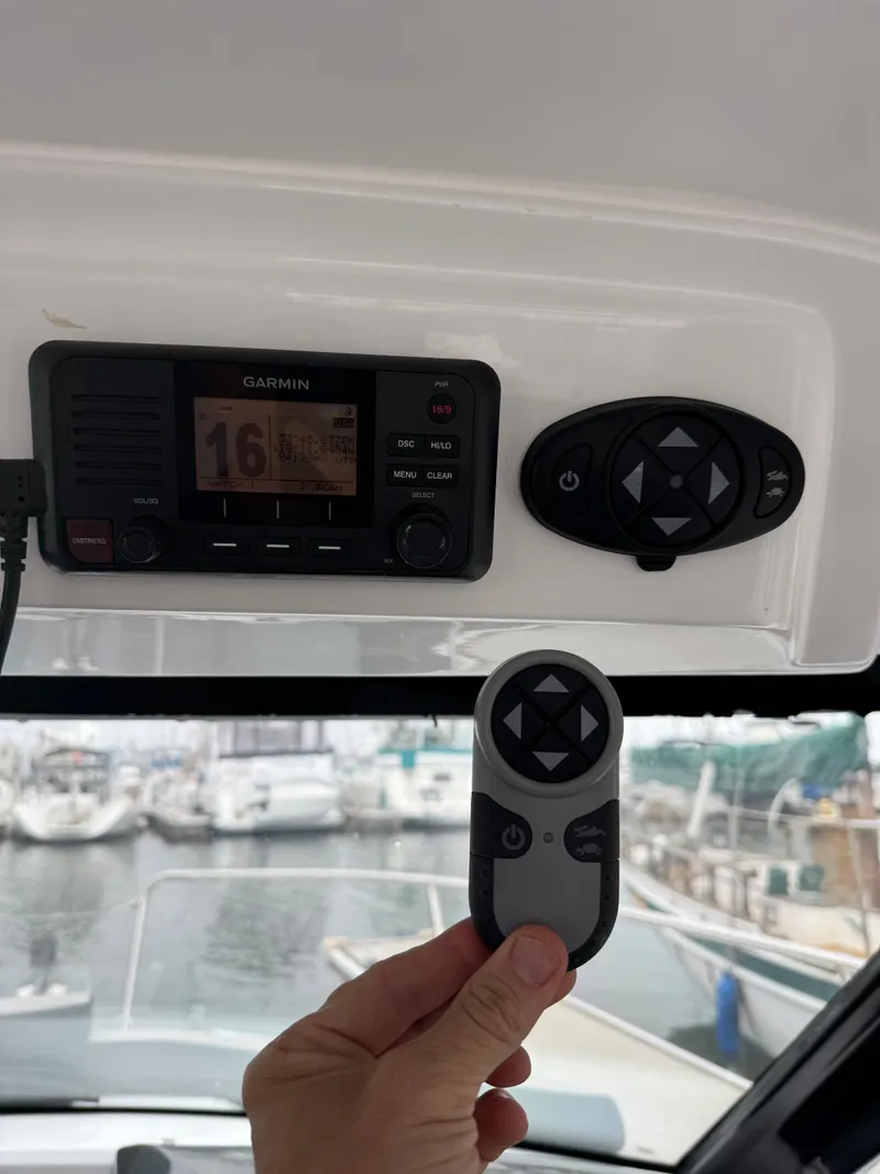 Slide: The Image of Control panel and remote on a 2020 Jeanneau NC 795 boat. - 44