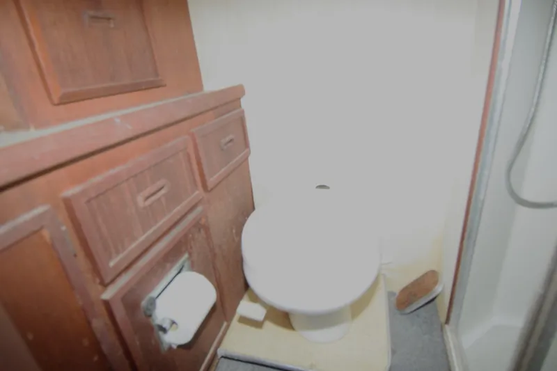 Slide: The Image of 1977 Uniflite 42 Double Cabin bathroom with wooden cabinets and shower. - 12