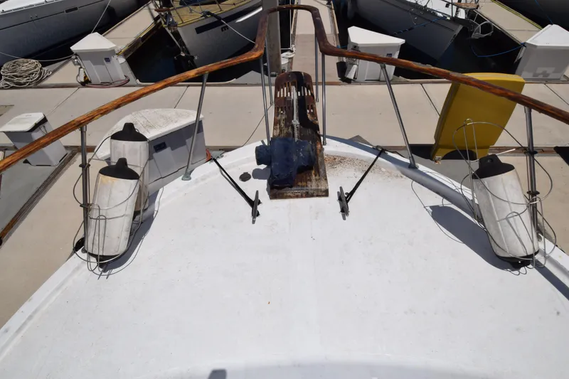 Slide: The Image of 1977 Uniflite 42 Double Cabin boat deck with fenders and dock view. - 15
