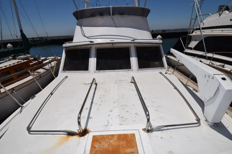 Slide: The Image of 1977 Uniflite 42 Double Cabin boat deck with railing, docked at marina. - 17