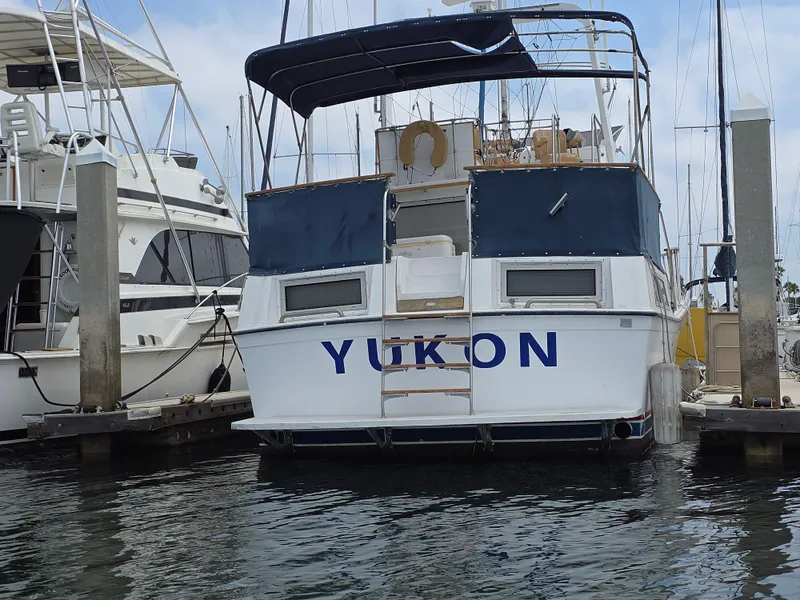 Slide: The Image of 1977 Uniflite 42 Double Cabin yacht docked at marina, rear view. - 25