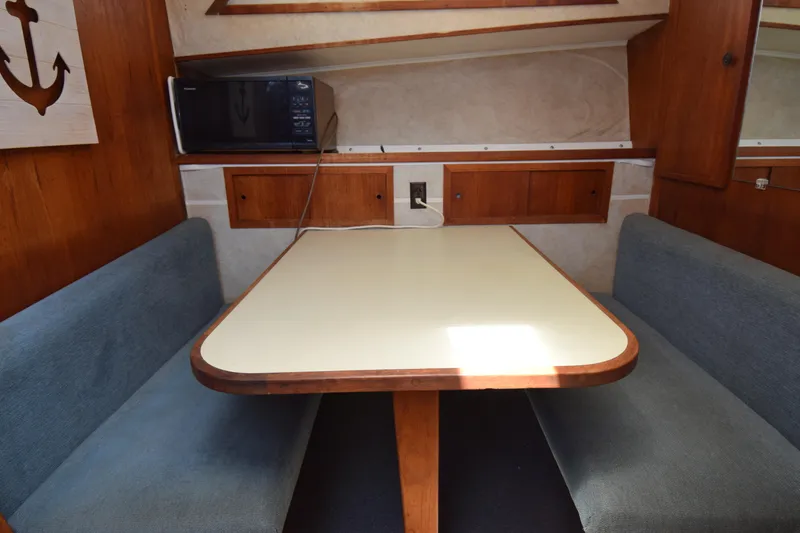 Slide: The Image of 1977 Uniflite 42 Double Cabin interior with dining area and microwave. - 4