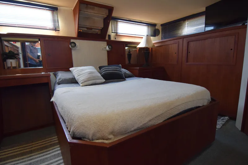 Slide: The Image of 1977 Uniflite 42 Double Cabin bedroom with cozy bed and wooden interior. - 6