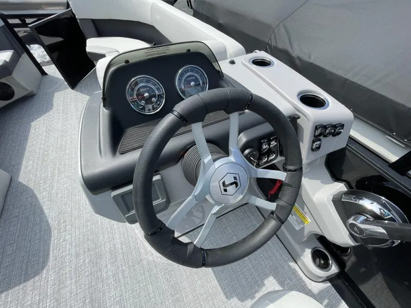 Slide: The Image of 2026 Harris Cruiser 230 boat dashboard with steering wheel and gauges. - 5