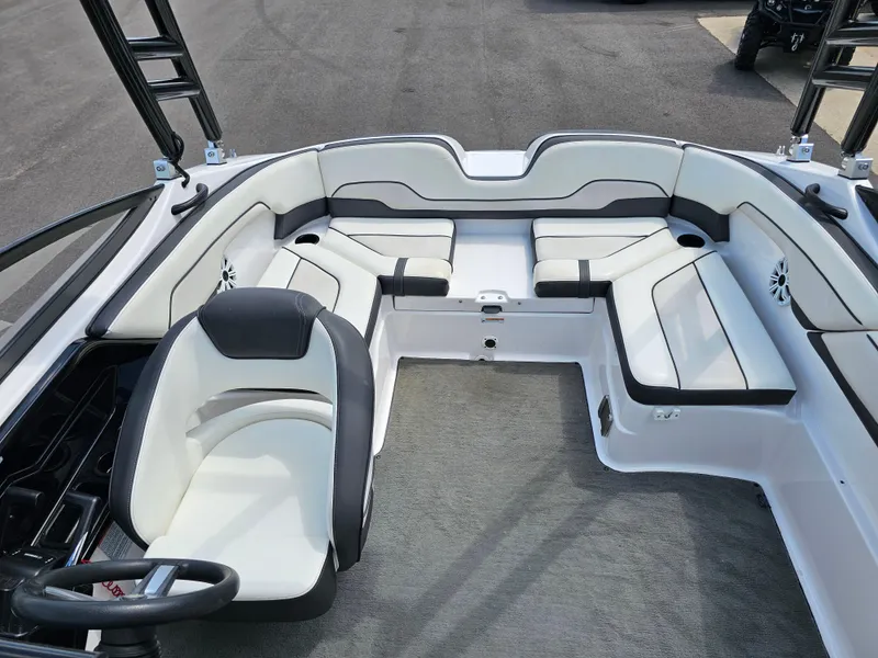 Slide: The Image of 2017 Yamaha Boats SX210 interior with white and black seating, spacious layout. - 12