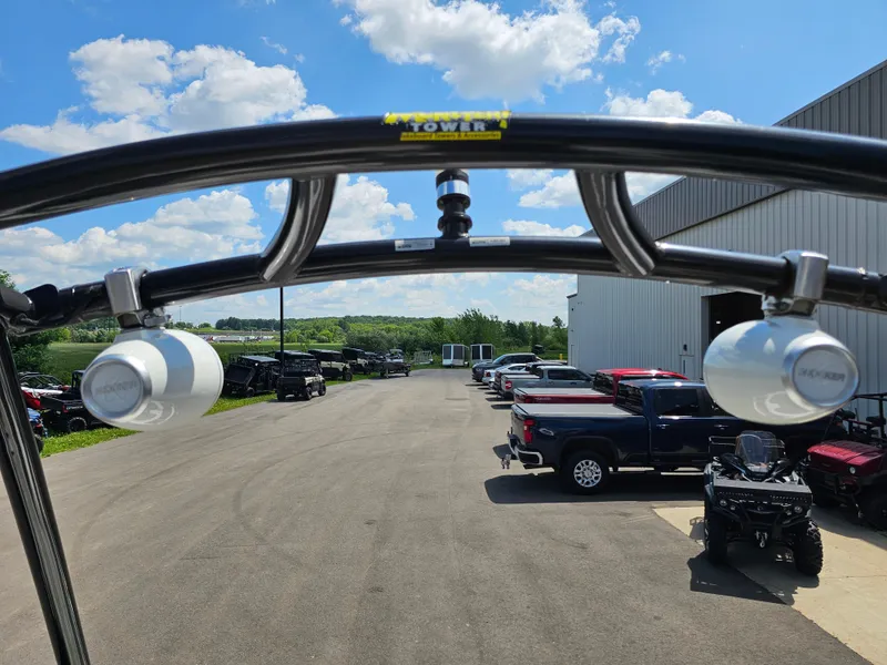 Slide: The Image of 2017 Yamaha Boats SX210 with speakers, parked near a warehouse under a clear blue sky. - 13