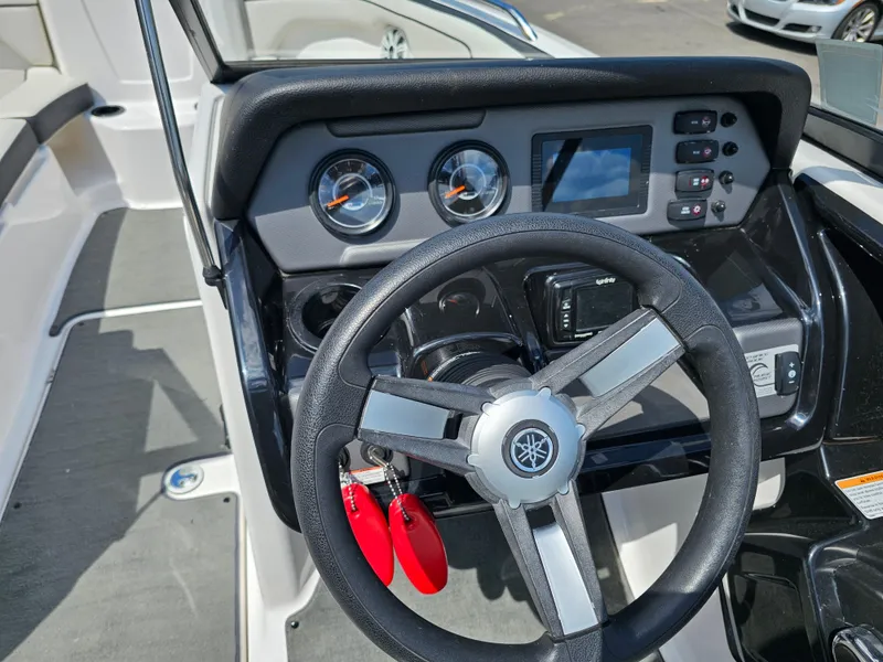 Slide: The Image of Steering wheel and dashboard of 2017 Yamaha Boats SX210, featuring gauges and controls. - 14
