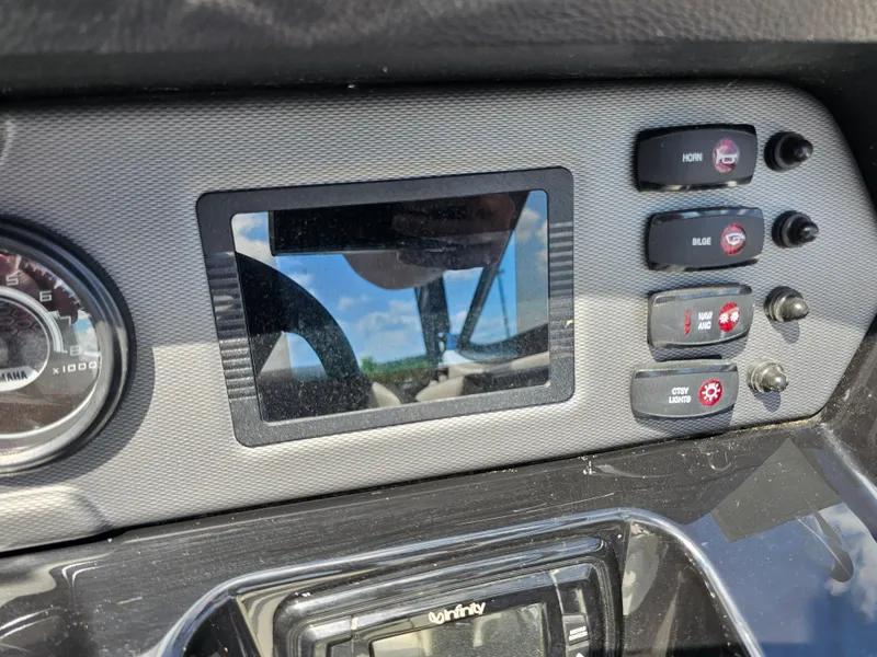 Slide: The Image of Dashboard of a 2017 Yamaha Boats SX210 with control switches and display screen. - 17