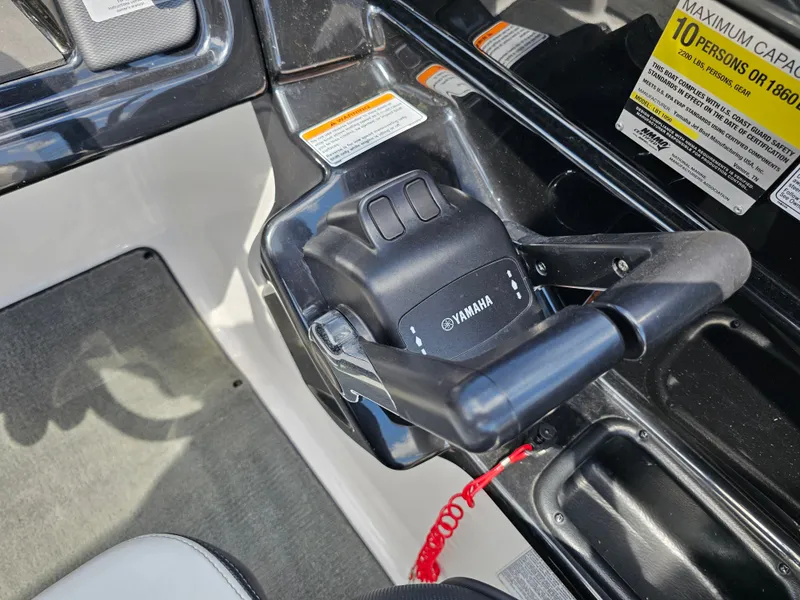 Slide: The Image of Control panel of a 2017 Yamaha Boats SX210, featuring throttle and safety warnings. - 19